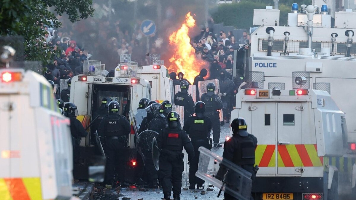 Riot police face off with protesters throwing bricks and petrol bombs in Newtownabbey, north Belfast, on Wednesday evening. Photo by Adam Vaughan/EPA