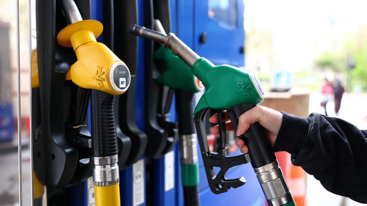 A woman holds a fuel nozzle at a petrol station in Paris, France, March 25, 2026. REUTERS/Abdul Saboor