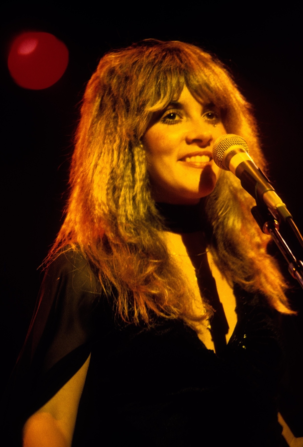 1977 The singer is seen here performing with Fleetwood Mac at the Berkeley Community Theater in February 1977. That month, their album Rumours was released, and it would go on to spend 31 weeks at the top of Billboard's Hot 200 Albums chart. Ed Perlstein/Redferns/Getty Images