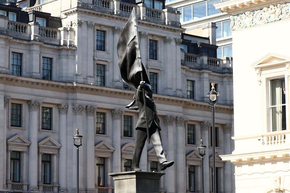 A statue depicting a person stepping off the plinth while carrying a flag covering their face, by British street artist Banksy, stands in London, Britain, April 30, 2026. REUTERS/Jack Taylor