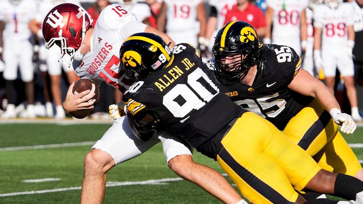  Iowa Hawkeyes defensive end Brian Allen (90) and Iowa Hawkeyes defensive lineman Aaron Graves (95) tackle Indiana Hoosiers quarterback Fernando Mendoza (15) Sept. 27, 2025 at Kinnick Stadium in Iowa City, Iowa. | Julia Hansen/Iowa City Press-Citizen / USA TODAY NETWORK via Imagn Images 