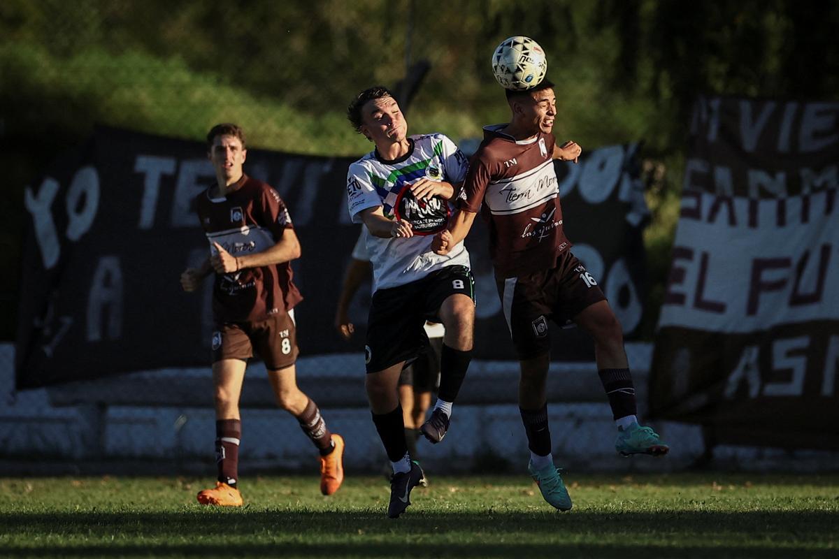 Emiliano Migueles, 26, playing for San Miguel de Las Heras, fights for the ball with a player from the opposing team EFIC Canuelas during a soccer match, part of the regional semi-amateur Liga de Lobos tournament, where some players are paid per game, in General Las Heras, Buenos Aires province, Argentina, April 12, 2026. REUTERS/Agustin Marcarian