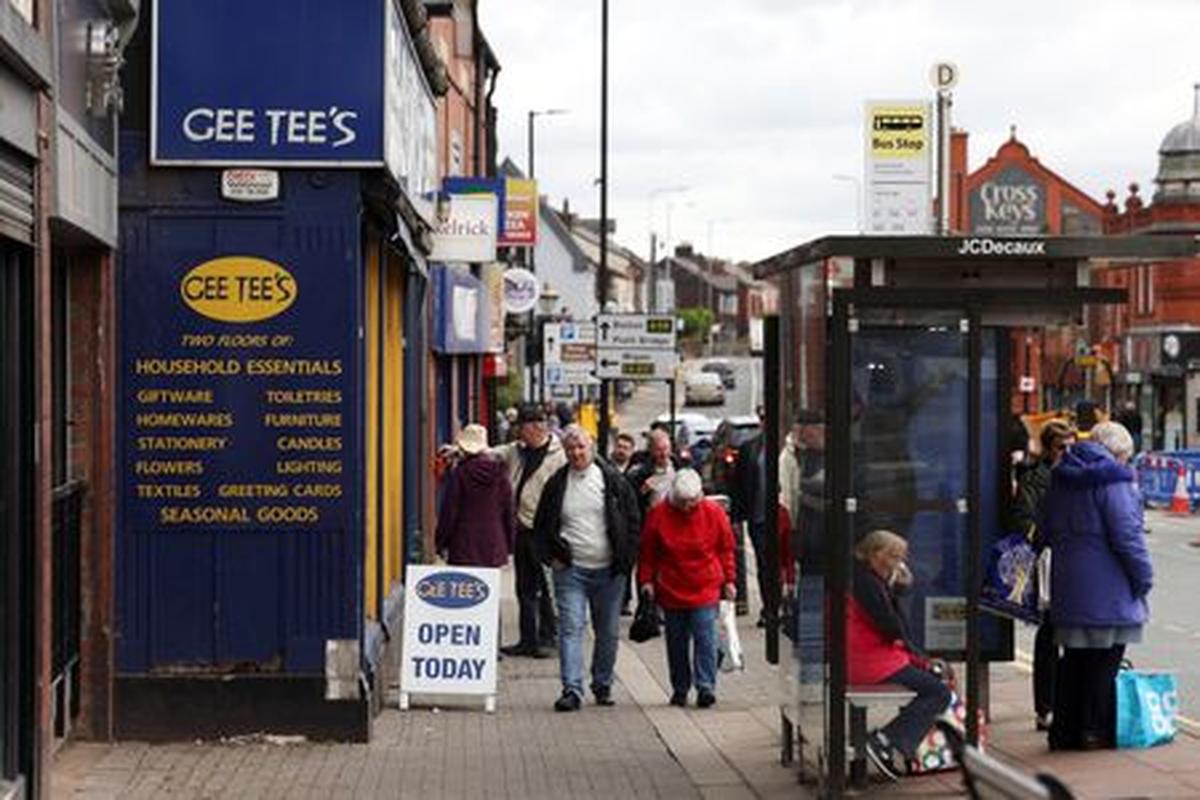 People walk along the high street, ahead of the Makerfield by-election, in Ashton-in-Makerfield, Britain, May 20, 2026. REUTERS/Temilade Adelaja