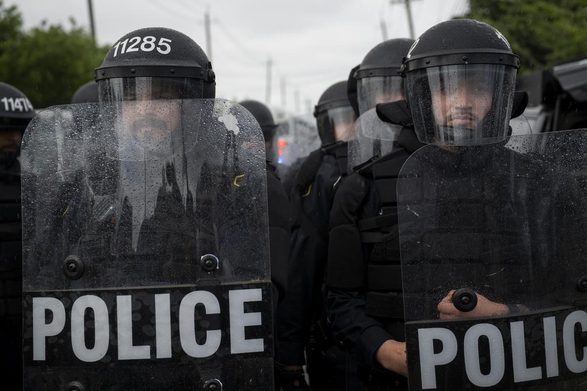 City of Newark police officers in riot gear monitor the anti-ICE demonstrations and counterprotests outside Delaney Hall, a federal detention facility in Newark, N.J. on Saturday, May 30, 2026. Clashes between protesters and armed federal agents here have flared off and on since the Memorial Day weekend; on Friday, federal officials left the area outside the detention center so that the state police could assume control. (Vincent Alban/The New York Times)