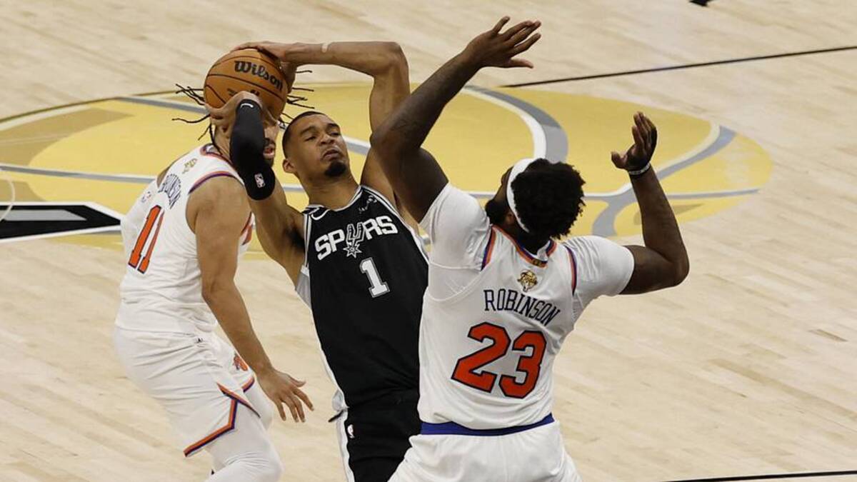  Jun 3, 2026; San Antonio, Texas, USA; San Antonio Spurs forward Victor Wembanyama (1) shoots the ball against New York Knicks center Mitchell Robinson (23) in the second half during game one of the 2026 NBA Finals at Frost Bank Center. Mandatory Credit: Geoff Burke-Imagn Images | Geoff Burke-Imagn Images 