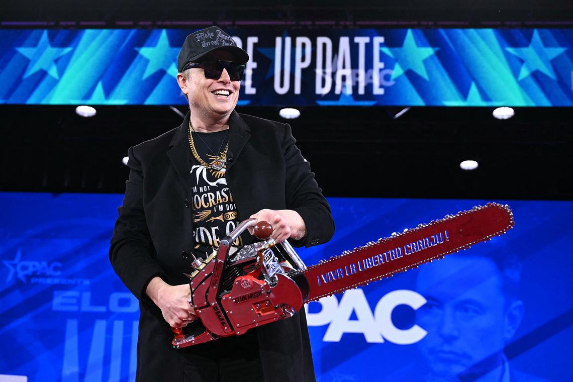 Elon Musk holds a chainsaw reading “Long live freedom, damn it” during the annual Conservative Political Action Conference (CPAC) at the Gaylord National Resort & Convention Center at National Harbor in Oxon Hill, Maryland, on Feb. 20, 2025.