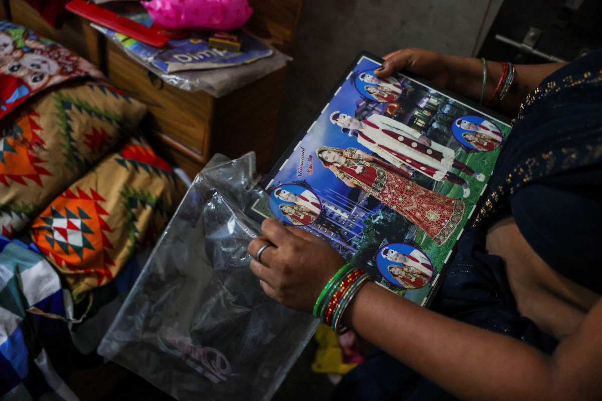 A relative holds a wedding photo of Shivanand Chaurasia, an Indian seafarer aboard the Palau-flagged tanker MT Settebello, who was among three crew members killed in one of the U.S. attacks on Indian-crewed tankers this week amid a blockade of Iran-related shipping, as it's kept inside a plastic wrapper, in Deoria, Uttar Pradesh, India, June 12, 2026. REUTERS/Priyanshu Singh
