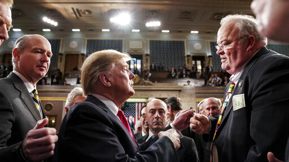 Former President Donald Trump talks with Rep. Billy Long, R-Mo., after giving his State of the Union address to a joint session of Congress, Tuesday, Feb. 5, 2019 at the Capitol in Washington.