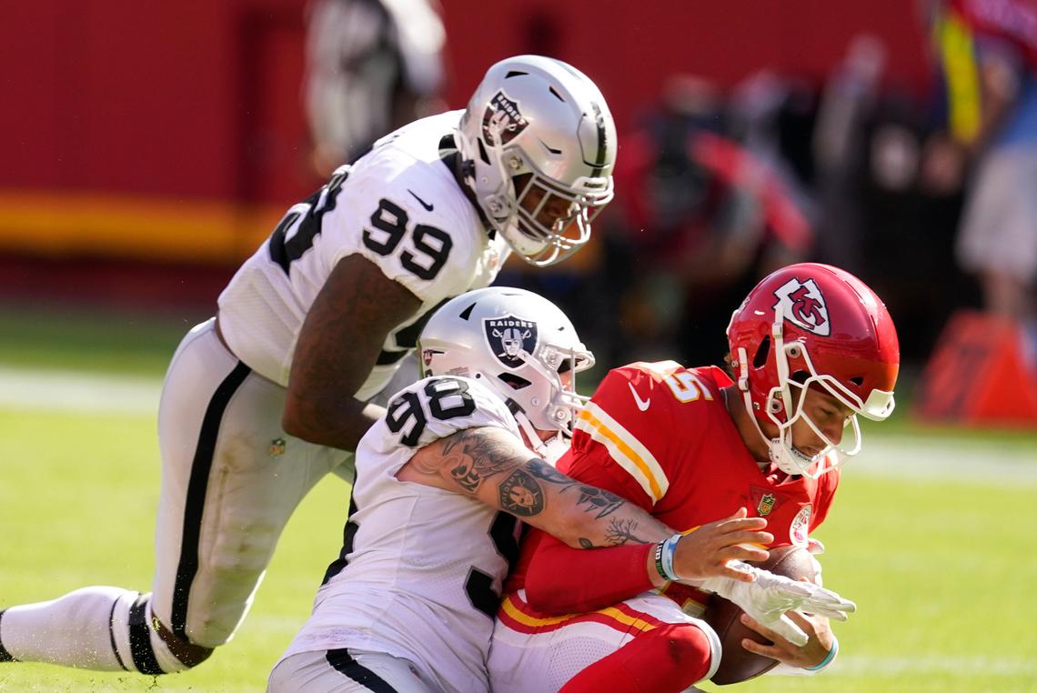 Kansas City Chiefs quarterback Patrick Mahomes (15) was sacked by Las Vegas Raiders defensive end Maxx Crosby (98) and defensive end Arden Key (99) during the second half of an NFL football game, Sunday, Oct. 11, 2020, in Kansas City.