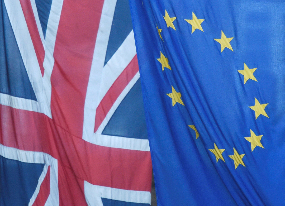 FILE PHOTO: A Union flag flies next to the flag of the European Union in Westminster, London, Britain June 24, 2016.    REUTERS/Toby Melville/File Photo