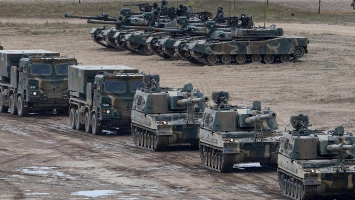 South Korean-made K1E1 tanks (background R), K9 howitzers (front) and Chunmoo multiple rocket launchers (L) are on standby for an integrated field maneuver at the training field of the Army's 17th Division in Incheon, 27 kilometers west of Seoul, South Korea. File. Photo by YONHAP / EPA