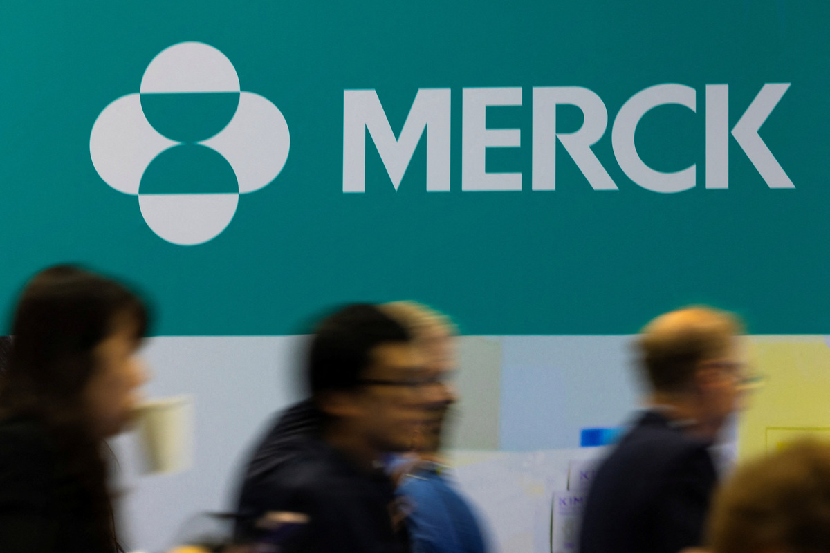 Attendees walk past the Merck logo at the BIO International Convention 2026, a meeting of pharmaceutical and biotechnology leaders in San Diego, California, U.S. June 23, 2026. REUTERS/Mike Blake