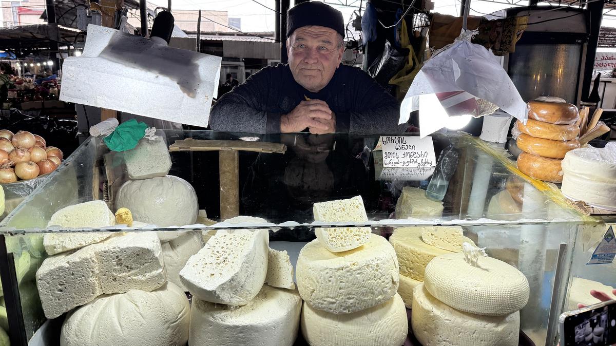 A cheesemonger oversees one of many food stalls at the Telavi market in Khaketi, Georgia's best-known wine region. (Lori Rackl/TNS)
