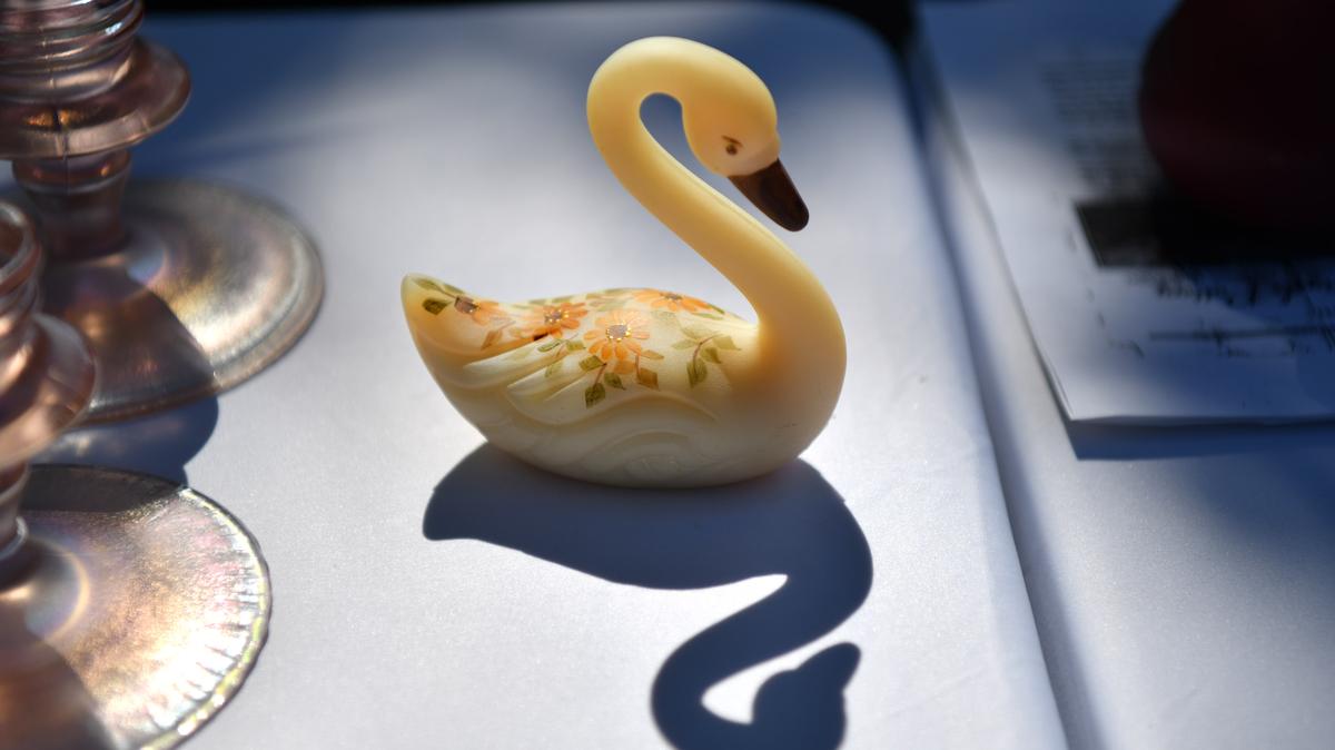 A small decorative swan figurine is bathed in the morning sunlight as it awaits to be purchased during the "Relics on Railroad" Antiques and Art Faire held at the Museum of the San Ramon Valley in Danville on Sept. 6, 2021. (Jose Carlos Fajardo/Bay Area News Group)