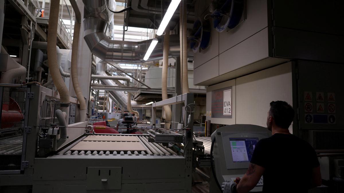 A worker looks on as tiles stand on conveyor rollers at Gruppo Romani ceramics factory production line. Italy's ceramic tile district of Sassuolo, responsible for more than 80% of national output, is among Europe's most energy‑intensive manufacturing hubs and increasingly exposed to turmoil in global energy markets as the Iran crisis deepens, in Rubiera, Italy, April 30, 2026. REUTERS/Claudia Greco