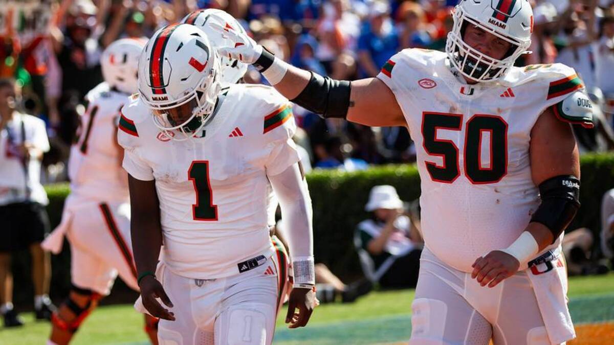  Miami Hurricanes quarterback Cam Ward (1) is congratulated by Miami Hurricanes center Zach Carpenter (50) after scoring a touchdown during the season opener at Ben Hill Griffin Stadium in Gainesville, FL on Saturday, August 31, 2024 against the University of Miami Hurricanes in the first half. Miami lead 24-10 at the half. [Doug Engle/Gainesville Sun] | USA TODAY Network via Reuters Connect 