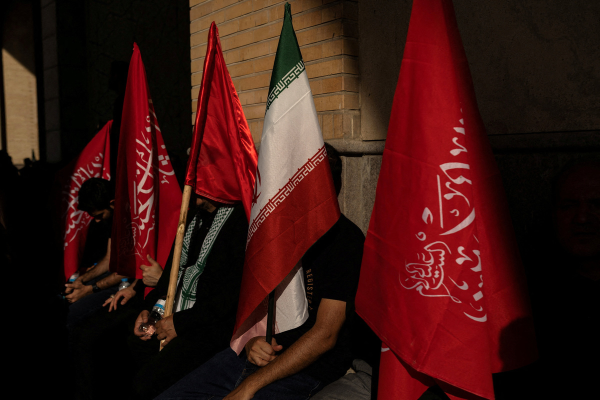 Mourners hold flags as they attend a prayer during a public farewell ceremony to pay their respects to late Supreme Leader Ayatollah Ali Khamenei, who was killed on February 28 in Israeli and U.S. airstrikes, at the Imam Khomeini Grand Mosalla, in Tehran, Iran July 5, 2026. REUTERS/Alkis Konstantinidis Foreign media in Iran operate under guidelines set by the Ministry of Culture and Islamic Guidance, which regulates press activity and permissions