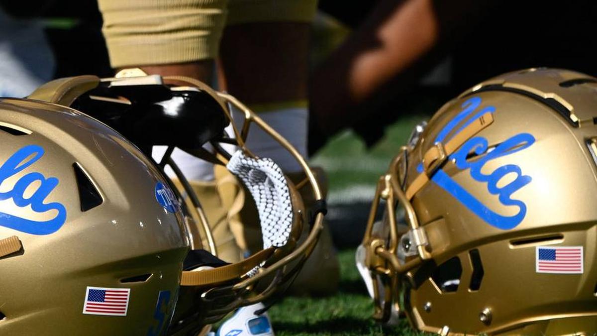 Nov 30, 2024; Pasadena, California, USA; UCLA Bruins helmets during pregame warmups before playing the Fresno State Bulldogs at Rose Bowl. Mandatory Credit: Robert Hanashiro-Imagn Images | Robert Hanashiro-Imagn Images 