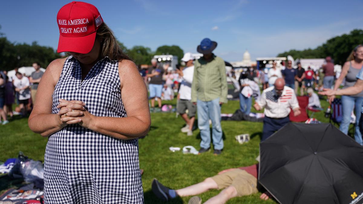 A woman wears a Make America Great Again (MAGA) hat as U.S. House Speaker Mike Johnson (R-LA) (not pictured) leads a prayer at the Rededicate 250: A National Jubilee of Prayer, Praise & Thanksgiving at the National Mall in Washington, D.C., U.S., May 17, 2026. REUTERS/Seth Herald