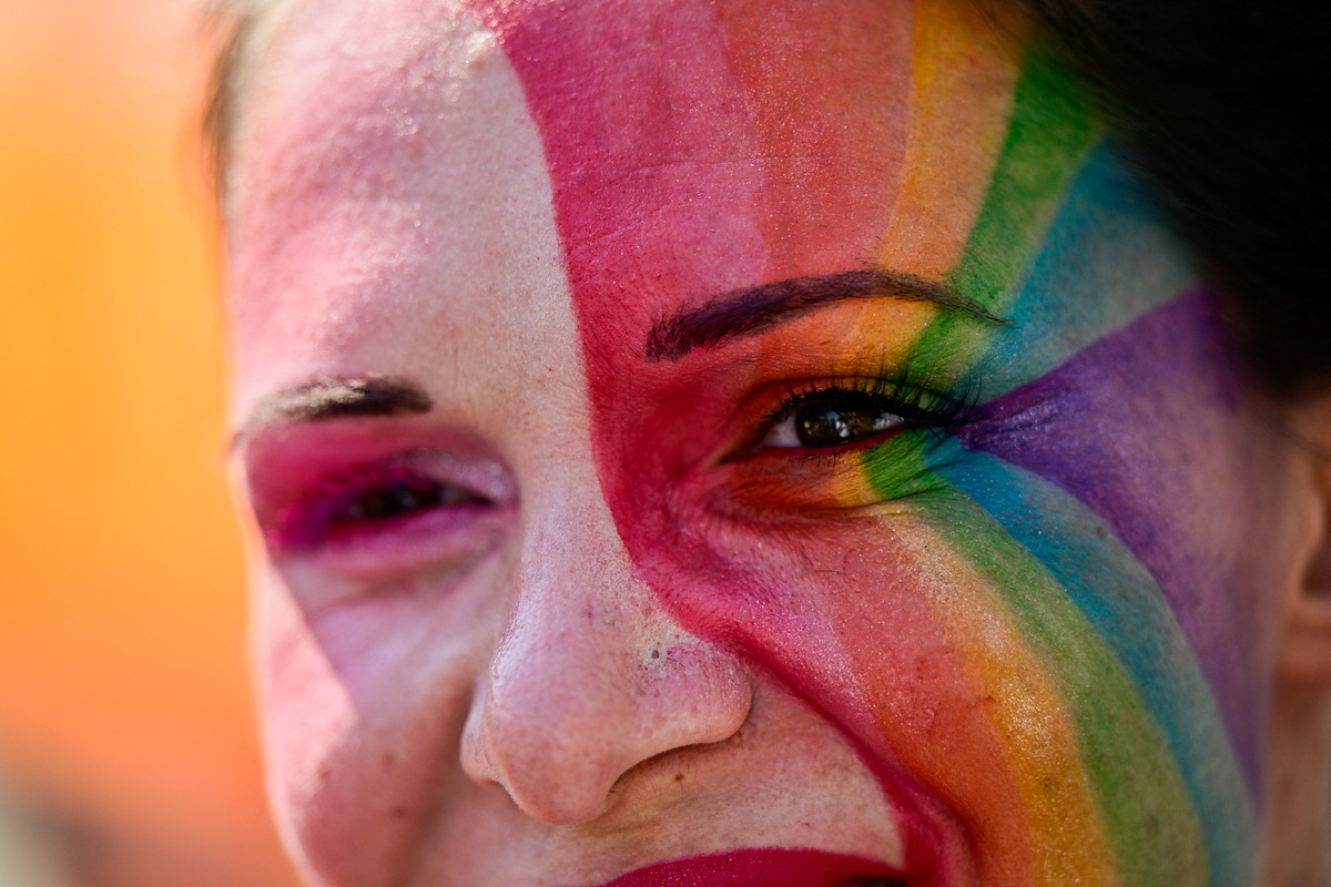 A person wears make-up in the colors of a Pride flag as people attend the Budapest Pride march in Budapest, Hungary, June 27, 2026. REUTERS/Marton Monus