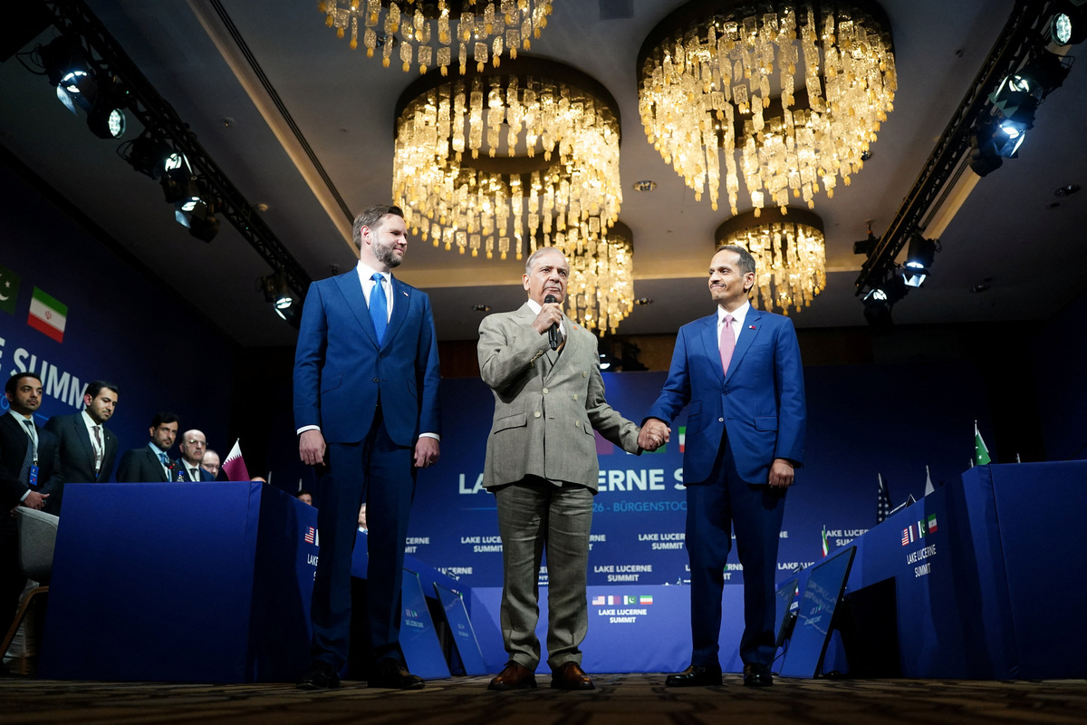 U.S. Vice President JD Vance looks on as Pakistan's Prime Minister Shehbaz Sharif speaks while holding the hand of Qatar's Prime Minister and Minister for Foreign Affairs Sheikh Mohammed bin Abdulrahman bin Jassim Al-Thani at the start of a quadrilateral meeting between the U.S., Iran, Pakistan, and Qatar at the Lake Lucerne Summit, aimed at advancing a deal to end the Middle East conflict, at Buergenstock Resort Lake Lucerne, near Stansstad, Switzerland, June 21, 2026. REUTERS/Nathan Howard/Pool