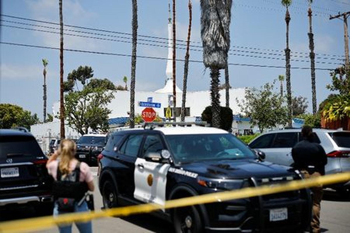 Emergency workers respond at the scene of a reported active shooter situation at the Islamic Center, with yellow tape to cordon the area in the foreground, in San Diego, California, U.S., May 18, 2026.  REUTERS/Mike Blake