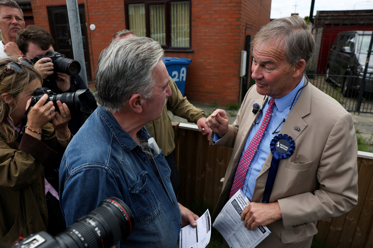 Rupert Lowe of Restore Britain campaigns on a street during the Makerfield by-election, triggered by the resignation of Labour MP John Simons, in Wigan, Britain, June 18, 2026. REUTERS/Temilade Adelaja