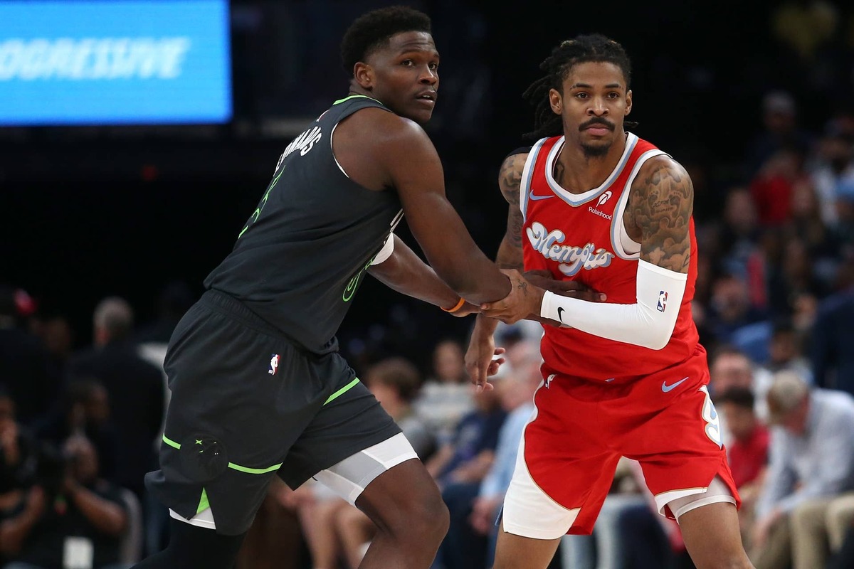  Minnesota Timberwolves guard Anthony Edwards (5) and Memphis Grizzlies guard Ja Morant (12) battle for position at FedExForum. 