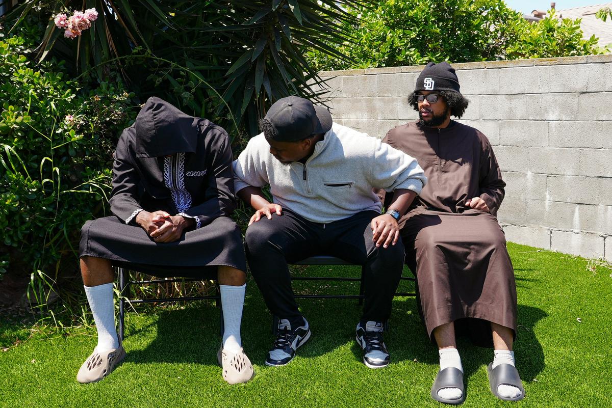 Jibril Abdullah, Mohammed Abdullah and Khalid Abdullah, sons of security guard Amin Abdullah, who was killed in a shooting incident, sit outside their home in San Diego, California, U.S., May 20, 2026. REUTERS/Arafat Barbakh