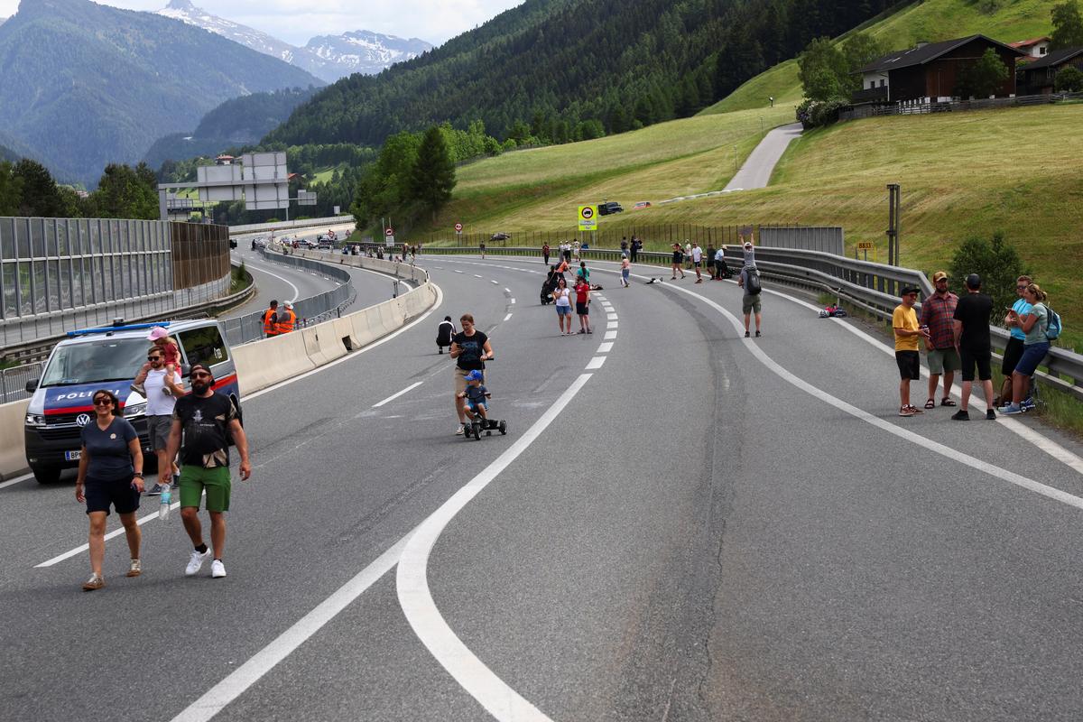 People walk on a closed motorway as they protest against the growing traffic load on the Brenner motorway between Austria and Italy, near Matrei, Austria, May 30, 2026. REUTERS/Christian Mang
