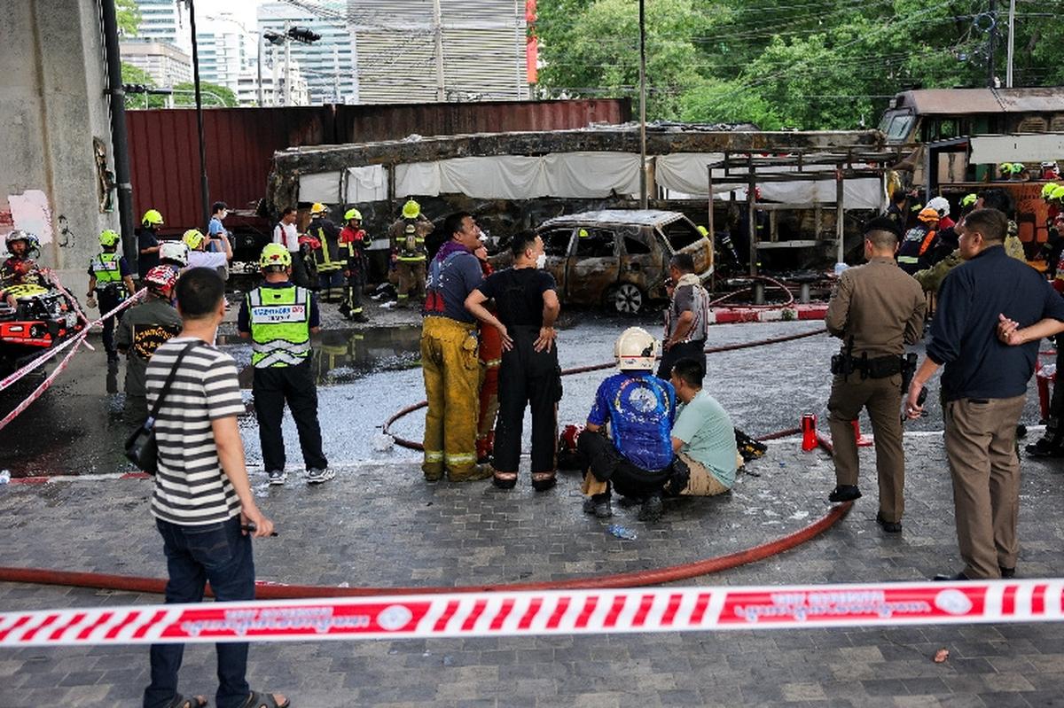 Emergency services work at a site where a train collided with a bus, several cars and motorcycles on Asok-Din Daeng Road, causing several casualties, in Bangkok, Thailand, May 16, 2026. REUTERS/Athit Perawongmetha