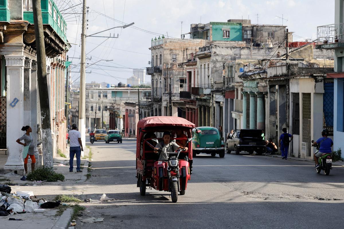 FILE PHOTO: A man drives an electric rickshaw along an avenue as Cuba's electrical grid suffered a partial collapse early Thursday morning, cutting power across eastern Cuba amid a U.S. fuel blockade, in Havana, Cuba, May 14, 2026. REUTERS/Norlys Perez/File Photo