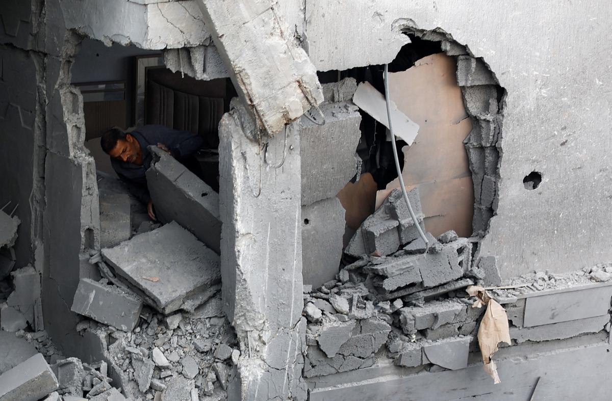 A Palestinian man inspects the site of an Israeli airstrike on a residential building on Tuesday, in Gaza City, May 27, 2026. REUTERS/Mahmoud Isaa