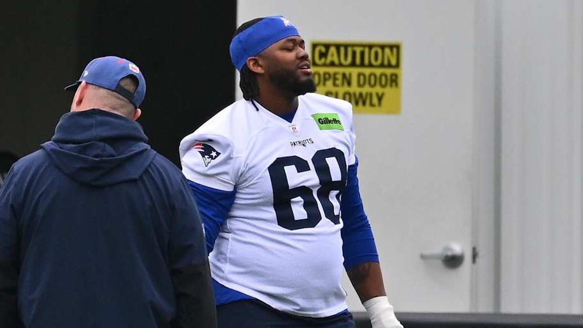  May 9, 2026; Foxborough, MA, USA; New England Patriots rookie tackle Caleb Lomu (74) talks to a member of the coaching staff at the New England Patriots rookie camp at Gillette Stadium. Mandatory Credit: Eric Canha-Imagn Images | Eric Canha-Imagn Images 