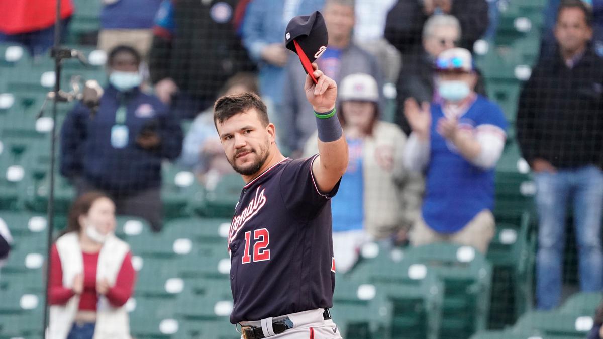 Washington Nationals left fielder Kyle Schwarber (12) tips his cap as the former Cub is honored before a baseball game against the Chicago Cubs, Monday, May, 17, 2021, in Chicago. (AP Photo/David Banks)