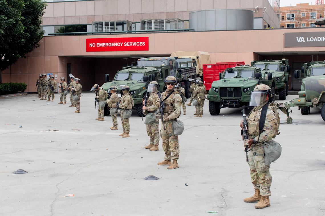 Members of the California National Guard stand outside the Edward R. Roybal Federal Building in downtown Los Angeles on Sunday.