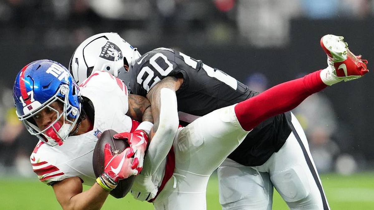  Dec 28, 2025; Paradise, Nevada, USA; New York Giants wide receiver Wan'Dale Robinson (17) is tackled by Las Vegas Raiders safety Isaiah Pola-Mao (20) in the first half at Allegiant Stadium. Mandatory Credit: Stephen R. Sylvanie-Imagn Images | Stephen R. Sylvanie-Imagn Images 