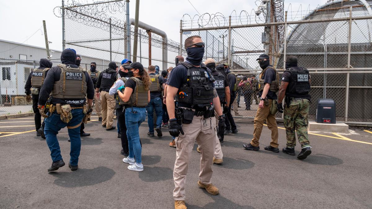 Federal law enforcement officers from various agencies after demonstrators blocked a bus outside of Delaney Hall in Newark, N.J., June 13, 2025. Four men escaped from the privately run immigration detention center in Newark during a disturbance on Thursday after days of unrest over conditions, according to a law enforcement official in New Jersey, a federal spokeswoman and other detainees’ lawyers. (Dakota Santiago/The New York Times)