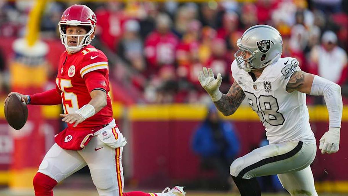  Nov 29, 2024; Kansas City, Missouri, USA; Kansas City Chiefs quarterback Patrick Mahomes (15) scrambles from Las Vegas Raiders defensive end Maxx Crosby (98) during the first half at GEHA Field at Arrowhead Stadium. Mandatory Credit: Jay Biggerstaff-Imagn Images | Jay Biggerstaff-Imagn Images 