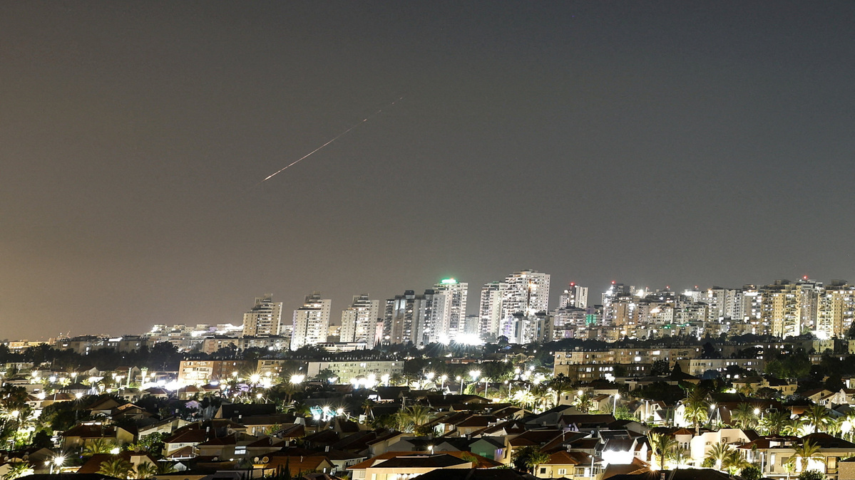 A streak of light illuminates the sky during a missile attack from Iran towards Israel as seen from Ashkelon, Israel, June 7, 2026. REUTERS/Amir Cohen