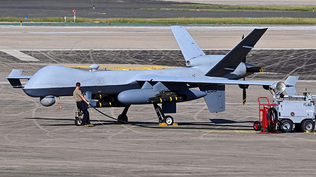 A US Air Force personnel prepares an MQ-9 Reaper drone for a mission on the tarmac at Rafael Hernandez Airport in Aguadilla, Puerto Rico, on Dec. 27, 2025.