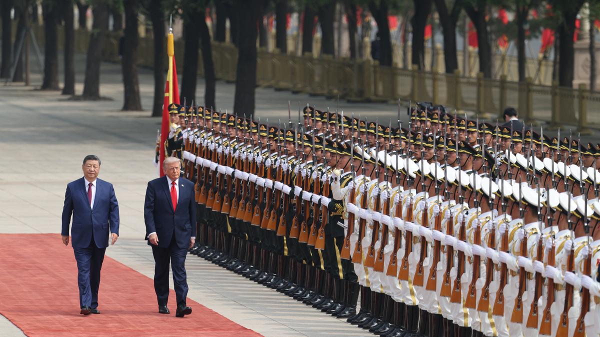 Chinese President Xi Jinping inspects an honour guard with U.S. President Donald Trump during a welcome ceremony at the Great Hall of the People, in Beijing, China, May 14, 2026. REUTERS/Maxim Shemetov/Pool