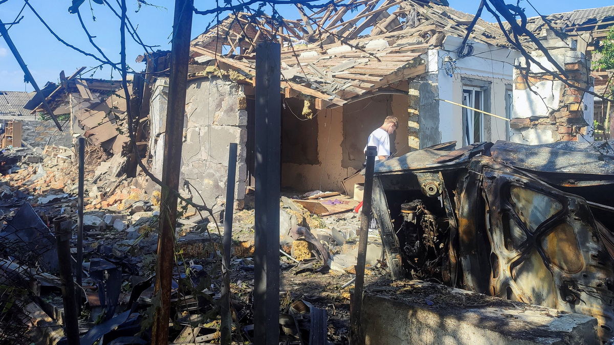 A resident stands at a site where a house was heavily damaged by a Russian drone strike, amid Russia's attack on Ukraine, in Mykolaiv, Ukraine June 12, 2026. Picture taken with a mobile phone. REUTERS/Viktoriia Lakezina