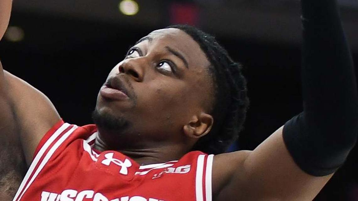  Mar 14, 2025; Indianapolis, IN, USA; UCLA Bruins guard Trent Perry (1) rebounds the ball against Wisconsin Badgers guard John Blackwell (25) during the second half at Gainbridge Fieldhouse. Mandatory Credit: Robert Goddin-Imagn Images | Robert Goddin-Imagn Images 