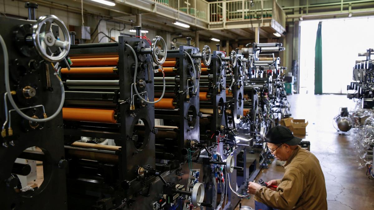 FILE PHOTO: A worker checks machinery at a factory in Higashiosaka, Japan June 23, 2022. REUTERS/Sakura Murakami/File Photo