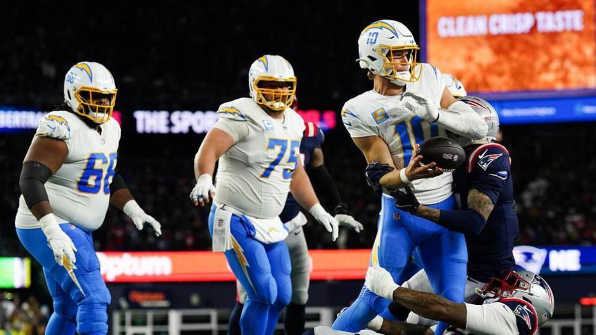  Jan 11, 2026; Foxborough, MA, USA; Los Angeles Chargers quarterback Justin Herbert (10) throws the ball away to avoid a sack during the second quarter against the New England Patriots in an AFC Wild Card Round game at Gillette Stadium. Mandatory Credit: David Butler II-Imagn Images | David Butler II-Imagn Images 