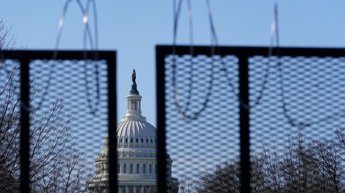 FILE - In this March 20, 2021, file photo the U.S. Capitol dome stands past partially-removed razor wire hanging from a security fence on Capitol Hill in Washington. Authorities suggested for weeks in court hearings and papers that members of the Oath Keepers militia group planned their attack on the Capitol in advance in an effort to block the peaceful transition of power. But prosecutors have since said it’s not clear whether the group was targeting the Capitol before Jan. 6, giving defense attorneys an opening to try to sow doubt in the government’s case. (AP Photo/Patrick Semansky, File)