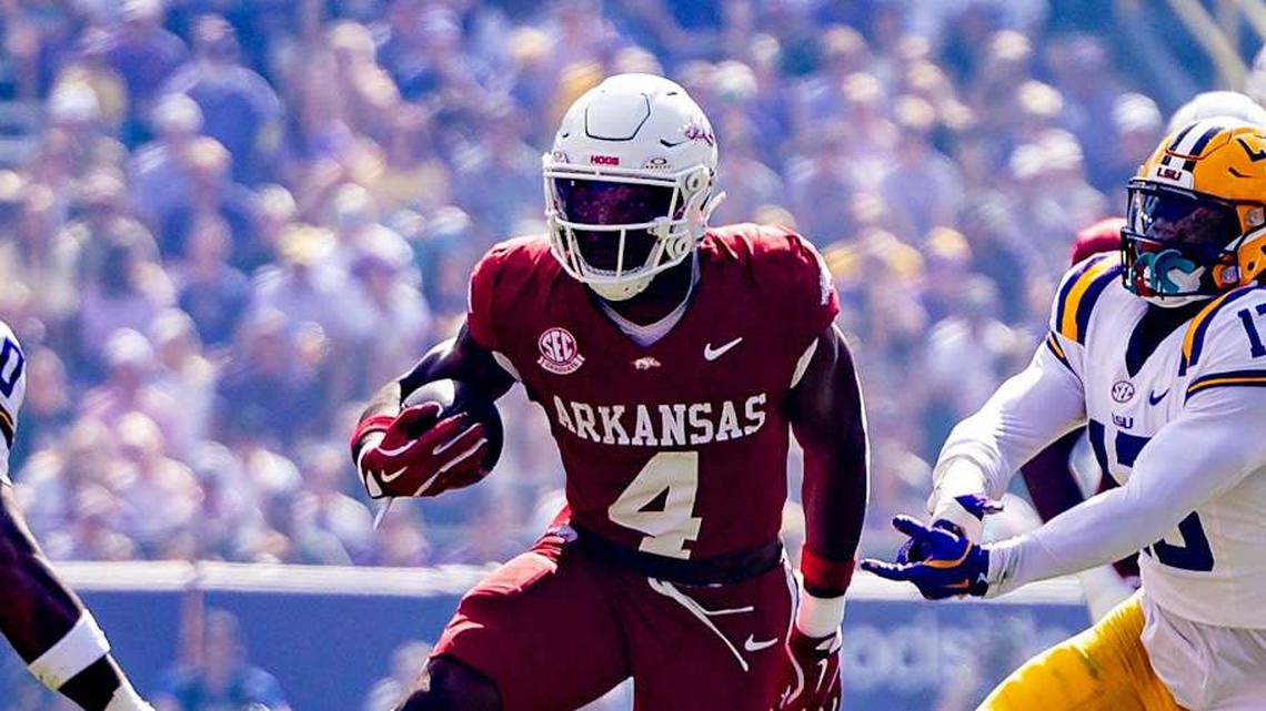  Nov 15, 2025; Baton Rouge, Louisiana, USA; Arkansas Razorbacks running back Mike Washington (4) runs against LSU Tigers safety Tamarcus Cooley (0) during the first half at Tiger Stadium. Mandatory Credit: Stephen Lew-Imagn Images | Stephen Lew-Imagn Images 