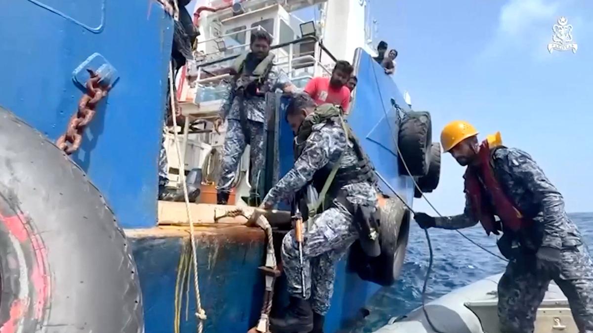 Pakistan Navy personnel climb onto the Indian vessel MV Gautam after receiving a distress call from the vessel following a critical technical failure in the Arabian Sea, according to Pakistan's military, in this still image obtained from a video released on May 5, 2026. ISPR/Handout via REUTERS