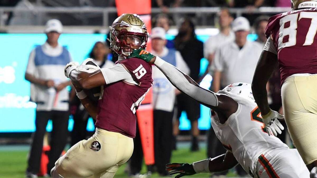  Oct 4, 2025; Tallahassee, Florida, USA; Florida State Seminoles wide receiver Micahi Danzy (19) is face masked by Miami Hurricanes linebacker Chase Smith (41) during the second half at Doak S. Campbell Stadium. Mandatory Credit: Robert Myers-Imagn Images | IMAGN IMAGES via Reuters Connect 